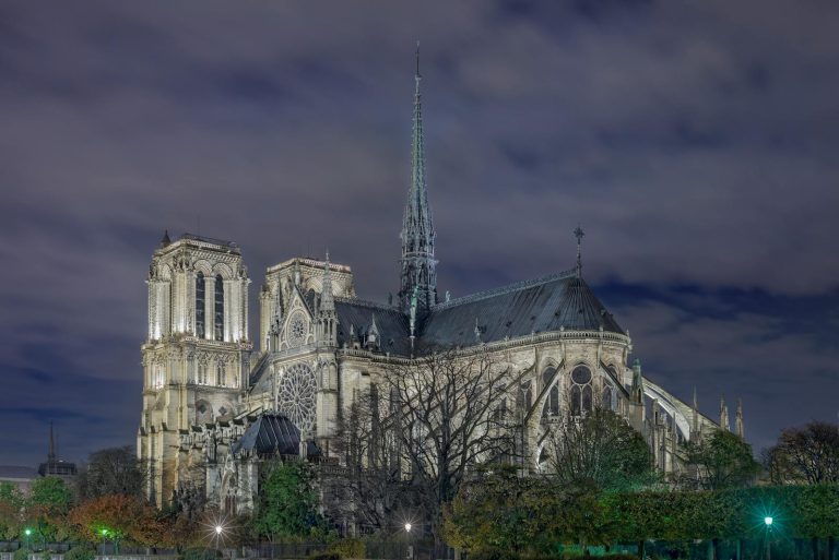 Stunning night view of Notre Dame Cathedral in Paris, France showcasing Gothic architecture.